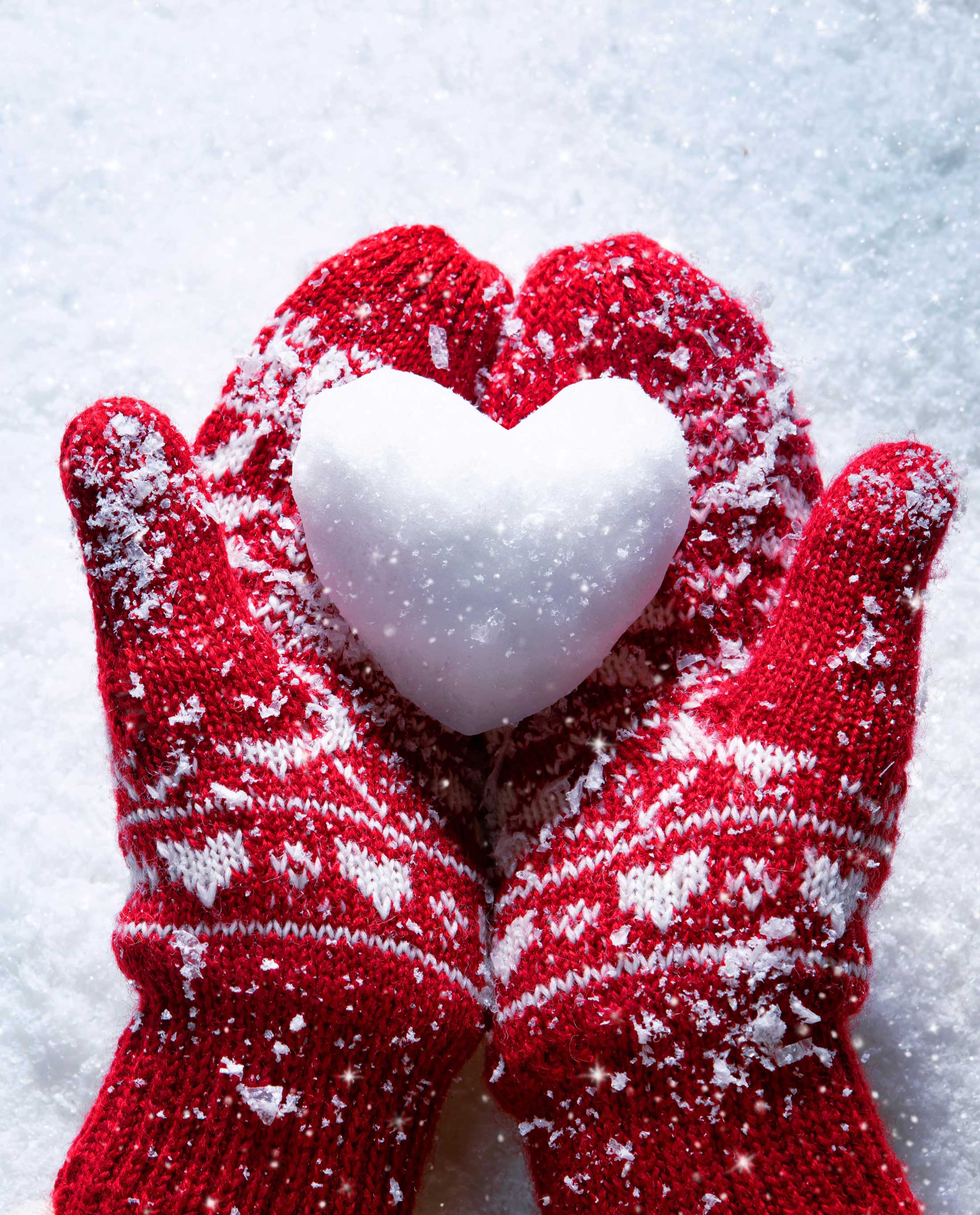 Two hands holding a snow heart